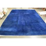 A large Chinese style blue rug with floral embroidery and beige fringing 275 x 375cm