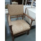A small oak arm chair upholstered in floral fabric