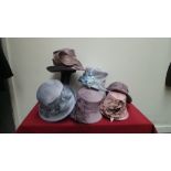 Mixed box of six lilac and pale blue occasion hats mainly labelled 'Whiteley'. All new with tags.