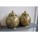 A pair of brass urns, with foliate-scroll engraving, with covers,