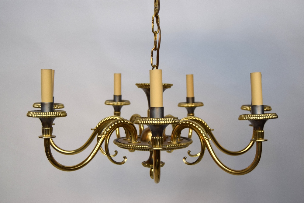 A 1920's brass seven branch chandelier, S-scroll arms with applied fern leaf decoration,