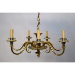 A 1920's brass seven branch chandelier, S-scroll arms with applied fern leaf decoration,