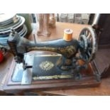 A late Victorian Singer sewing machine in a walnut case