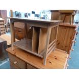 A 20th century design light oak side table with under shelf and magazine rack,