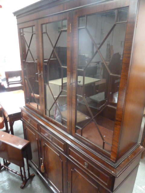 A 20th century mahogany dresser, glazed doors over three drawers and three panelled cupboards,