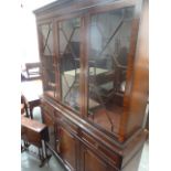 A 20th century mahogany dresser, glazed doors over three drawers and three panelled cupboards,