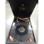 A His Majestys Voice gramophone and carry case together with a Gershwin record