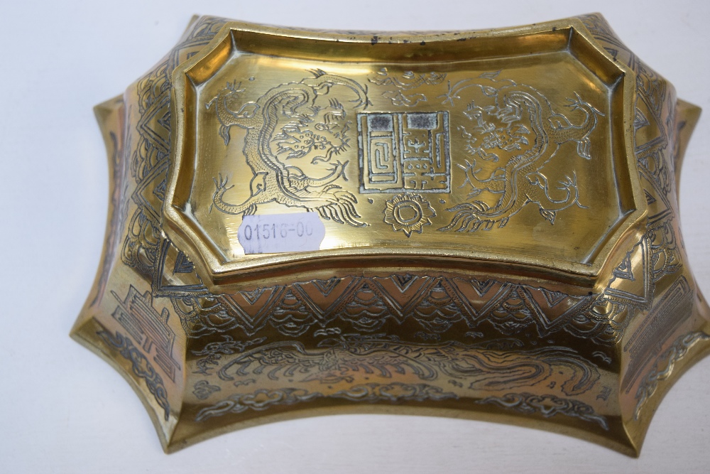 A Chinese brass bowl of serpentine form, decorated with foliage and dragons, stamp to base, - Image 2 of 2