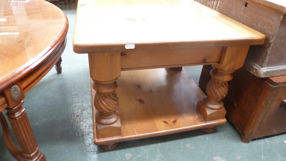 A pine square side table with four twist supports and under shelf on bun feet together with another