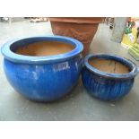 A blue glazed stoneware planter and another smaller of a similar design (2)
