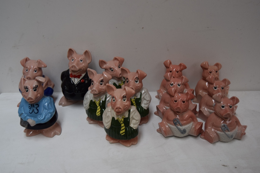 A collection of thirteen Wade Nat West pig money banks including six babies,
