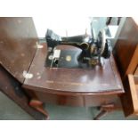 A sewing machine table, in mahogany case,