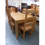 A modern oak kitchen table with six bar back chairs