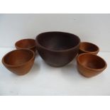 A large wooden serving bowl together with four smaller wooden bowls