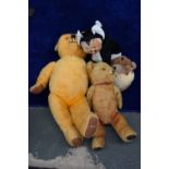 A selection of vintage stuffed toys including a Merrythought smiling cat with rubber face and