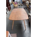 An Ercol light elm kitchen table on square tapered legs,