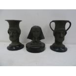 A pair of spelter candlesticks in the form of Roman urns, with the Roman god Janus' two faces,