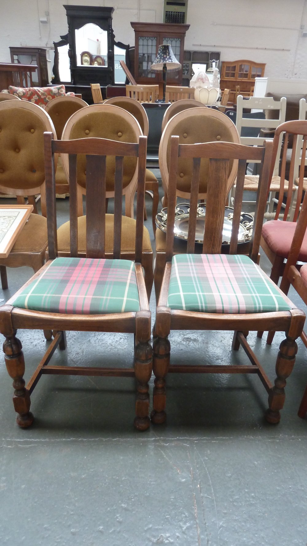 A pair of early 20th century oak slat back chairs,