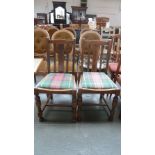 A pair of early 20th century oak slat back chairs,