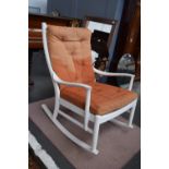 A circa 1970s Parker Knoll white rocking chair with loose cushions