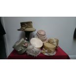 Mixed box of six cream and olive green occasion hats by 'Whiteley' and 'Mad Hatters'.