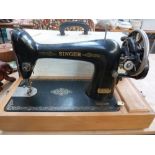A Singer Sewing machine in case with another Singer Starlet sewing machine