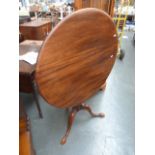 A mahogany bird cage action circular table, with splayed feet,