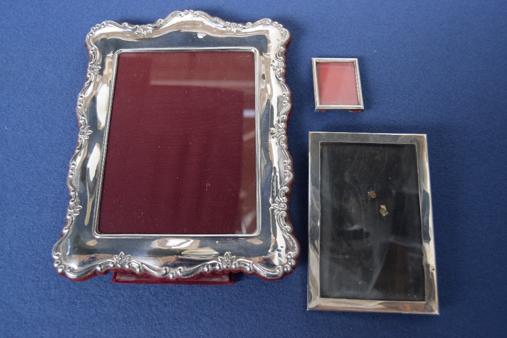 An Art Deco silver picture frame, by Deykin & Harrison, Birmingham 1925, with one smaller,