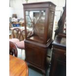 A 20th century mahogany display cabinet glazed top cupboard with internal shelves over panelled