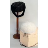 A soft white faux fur hat labelled 'Marzi' and a further Mitzi Lorenz black cocktail hat in a