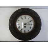An early 20th century circular wall clock, enamel dial with Roman numerals,