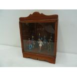 A wooden display case containing 7 pained sStarlux figures of 5 majorettes and 2 clowns (7)