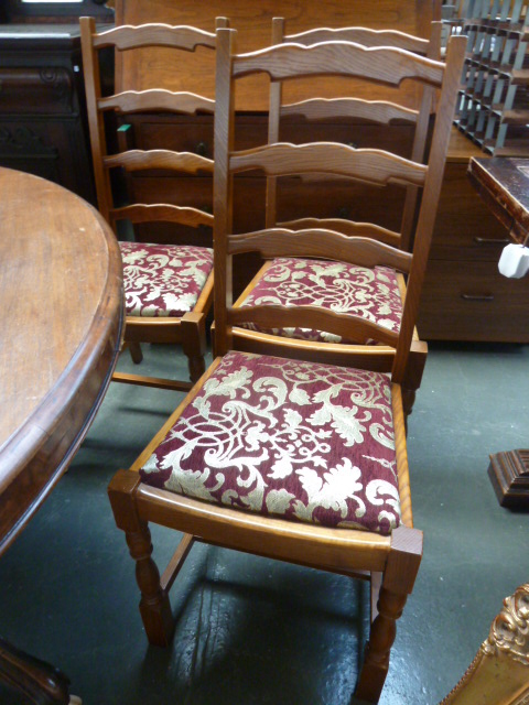 A set of four oak bar back chairs with block feet