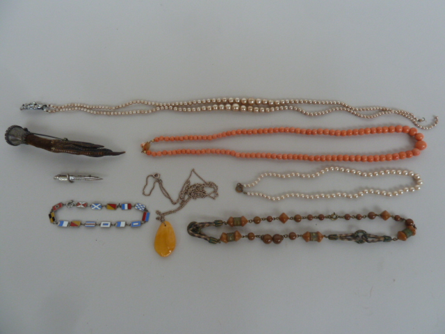 A quantity of costume jewellery to include a variety of necklaces, a brooch,