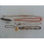 A quantity of costume jewellery to include a variety of necklaces, a brooch,