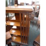 A large Edwardian oak revolving bookcase, three tiers, on splayed base,