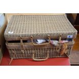 A wicker basket containing various embroidery and materials