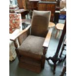 An early 20th century oak open armchair, wicker side panels with robust supports,