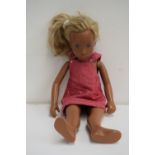 A Sasha Morgenthaler doll with long blonde hair and a red denim dress