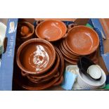 A box of terracotta stoneware items including various dishes,