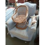 An Edwardian upholstered armchair with sky blue coverings,