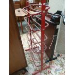 A red painted metal boot rack