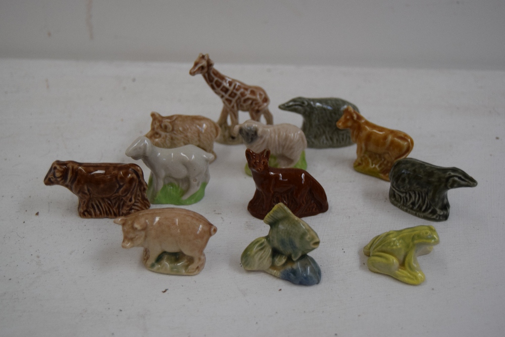 A collection of Wade Whimsies including a giraffe, pigs, tropical fish, sheep, cow, fox,