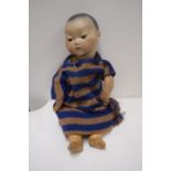 An Armand Marseille bisque head Oriental baby doll, with spray painted hair,