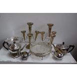 A box of silver plate items including two tea pots, a sugar bowl, milk jug,