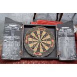 A Winmau SFB dartboard and wooden case