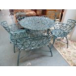 A metal green painted garden table and suite of four chairs together with a matching two seater