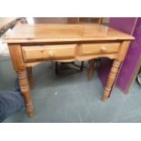 A pine dressing table with two drawers and tuned legs 75cmH x 90cmW