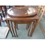A nest of three tables with glass tops and an Edwardian oval mirror