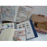 Four albums of British and World stamps together with a large number loose in labelled envelopes